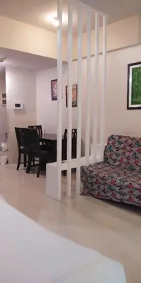 a living room with a couch and a table at Palm Tree Genlex Condo in Manila