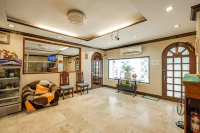 a living room with a couch and a window at Hotel Juliano in Manila