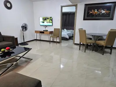 a living room with a couch and a table at Solemare Parksuites Condominium - Condo R Us in Manila