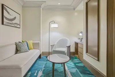 a living room with a couch and a chair at Holiday Inn & Suites Manila Galleria by IHG in Manila