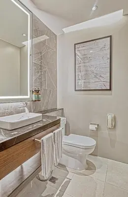 a white bathroom with a sink and a toilet at Crowne Plaza Manila Galleria by IHG in Manila