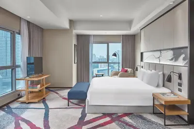 a hotel room with a bed and a tv at Crowne Plaza Manila Galleria by IHG in Manila