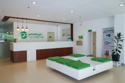 a waiting room at a hospital with green seats at Go Hotels Manila Airport Road in Manila
