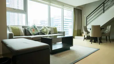 a living room with a couch and a table at Avant Serviced Suites - Personal Concierge in Manila