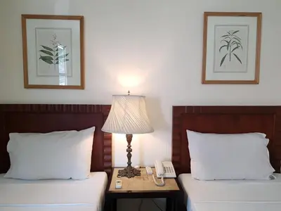 a hotel room with two beds with a lamp and a phone at Charming La Casita Mercedes, 5Br and 5TB for Family and Friends Staycation- Read Listing Info in Manila