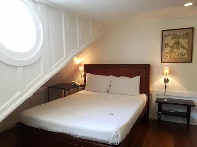 a bedroom with a white bed with a window at Charming La Casita Mercedes, 5Br and 5TB for Family and Friends Staycation- Read Listing Info in Manila