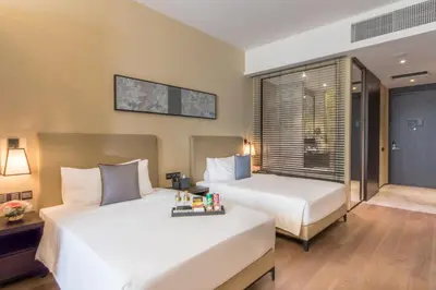 a hotel room with two beds and a window at I'M Hotel in Manila