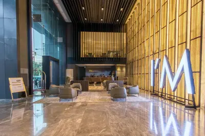 a lobby with a large m sign on the wall at I'M Hotel in Manila