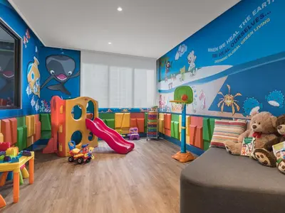 a childs room with blue walls and a play area at Somerset Alabang Manila in Manila