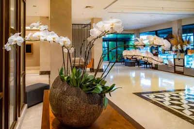 a vase filled with white flowers sitting on a table at The Bayleaf Cavite in General Trias