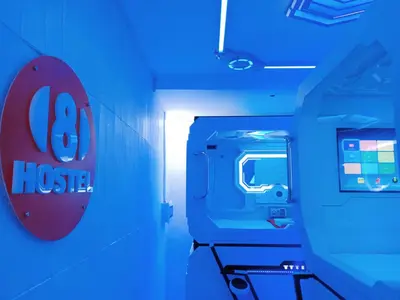 a blue room with a hsie sign on the wall at 8Hostel in Manila