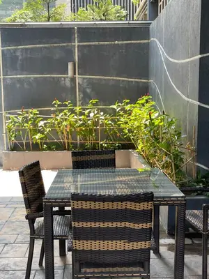 a table and chairs sitting on a patio at Luxury suite next to Shangrila and Westin Hotels in Manila