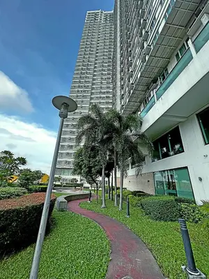 a street light in front of a tall building at The Beacon Residences Condominium in Manila