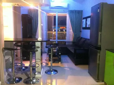 a living room with a table and a couch at Sea Residences MOA-Eric Apartments in Manila