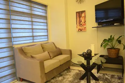 a living room with a couch and a table at Eton Parkview in Manila