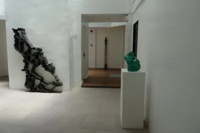 a museum with a sculpture on a pedestal in a hallway at Hotel Durban in Manila
