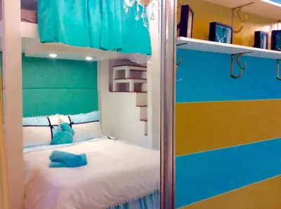 a bedroom with a bunk bed with a blue teddy bear at Tiffany Room At Shell Residences in Manila