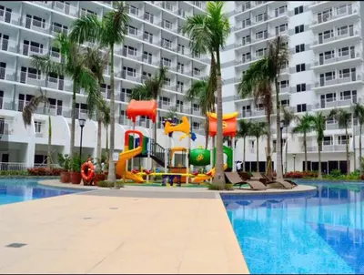 a playground in front of a large apartment building at Tiffany Room At Shell Residences in Manila