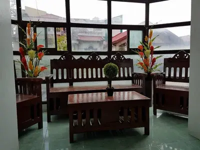 a restaurant with benches and a table with a plant on it at N&J Lopez Lodging House in Manila