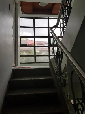 a stairway leading to a window in a building at N&J Lopez Lodging House in Manila