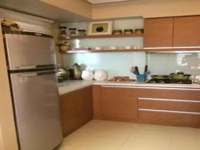 a kitchen with wooden cabinets and a stainless steel refrigerator at Sorrel Residences Condo Apartment by Fe in Manila