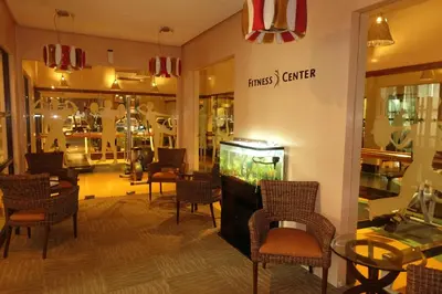 a store with a fish tank in a room with chairs at Modern Asian Condo at Forbeswood Parklane The Fort BGC in Manila