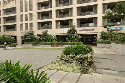 a large building with plants in front of it at Modern Asian Condo at Forbeswood Parklane The Fort BGC in Manila