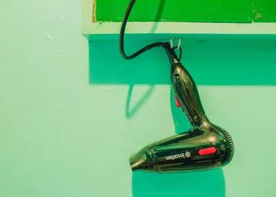 a pair of scissors hanging on a wall at Nomads MNL Backpackers Homestay - near Airport in Manila