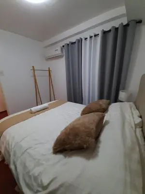 a bed with two pillows sitting on top of it at Affordable Makati APT in Manila