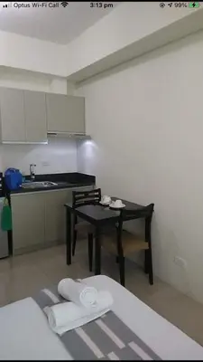 a room with a table and a kitchen with a table and chairs at Affordable Makati Serviced Apartments in Manila