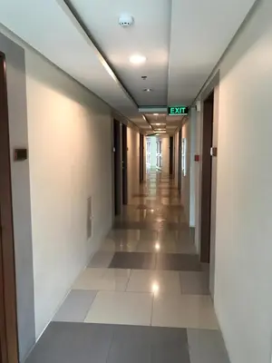 a hallway in an office building with a long corridor at Affordable Makati Serviced Apartments in Manila