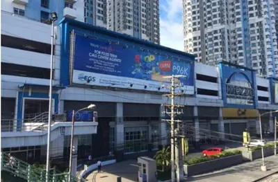 a building with a large billboard in a city at Sm Mezza Residences in Manila
