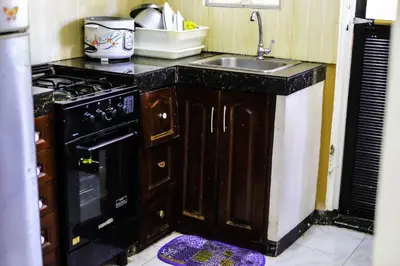 a kitchen with a sink and a stove at Entire House with 4 rooms near SM Molino and Vermosa Ayala in Imus