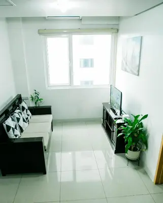 a living room with a couch and a tv at Salem's Abode in Manila