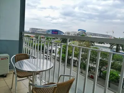 a balcony with a table and chairs and a view of a city at Salem's Abode in Manila