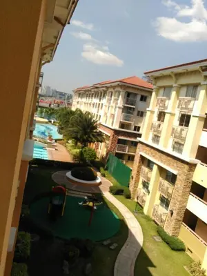 a view from the balcony of a apartment building with a playground at 2 BR Sorrento Oasis in Manila