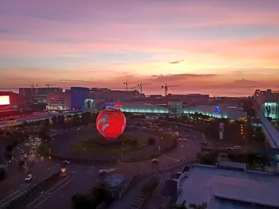 a large red balloon in a city at sunset at The Palawanos Home at Shell Residences in Manila