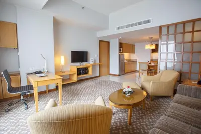 a living room with a couch and a table at The Linden Suites in Manila