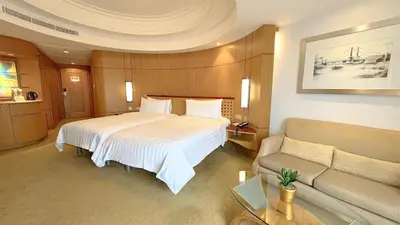 a hotel room with a bed and a couch at Makati Shangri-La, Manila in Manila