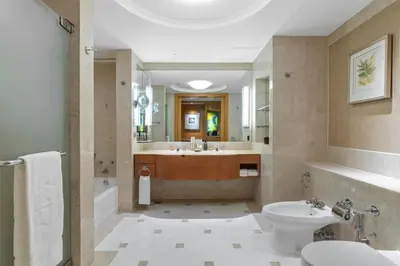 a bathroom with a tub and a sink and a toilet at Makati Shangri-La, Manila in Manila