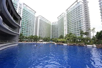 a swimming pool in front of some tall buildings at Maui Condotel Azure Residence in Manila