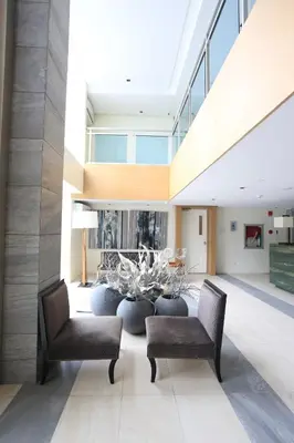 a living room with two chairs and a table at Maui Condotel Azure Residence in Manila