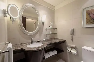 a bathroom with a sink and a mirror at Edsa Shangri-La, Manila in Manila