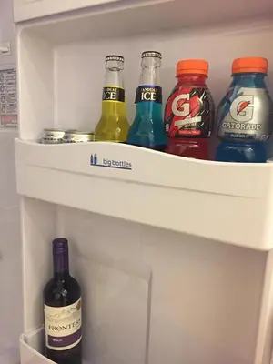 a refrigerator filled with bottles of soda and drinks at Luckycat Homestay in Manila