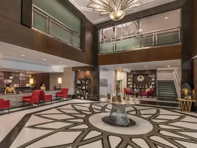 a lobby of a hotel with a table and chairs at Somerset Millennium Makati in Manila