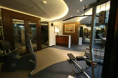 a gym with cardio equipment in a hotel room at Crown Regency Hotel Makati in Manila