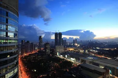 a view of a city skyline at night at The Malayan Plaza Hotel in Manila