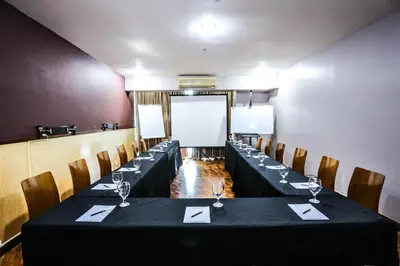 a conference room with a long table and chairs at The Malayan Plaza Hotel in Manila