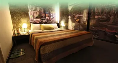 a bedroom with a bed with a painting on the wall at Eurotel Makati in Manila