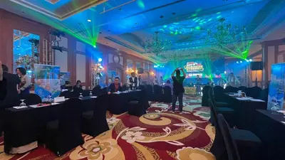 a group of people sitting at tables in a banquet hall at The Heritage Hotel Manila in Manila